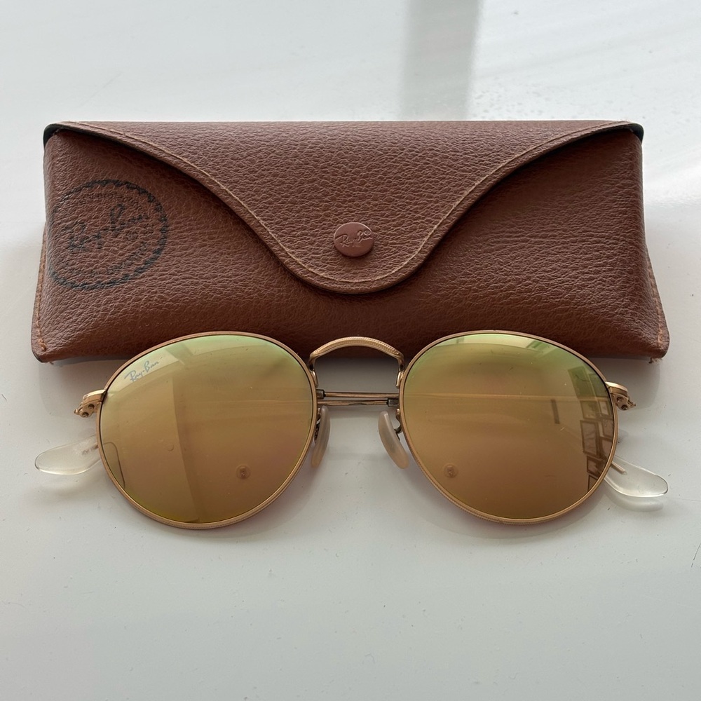 Ray-Ban rose gold round metal sunglasses.